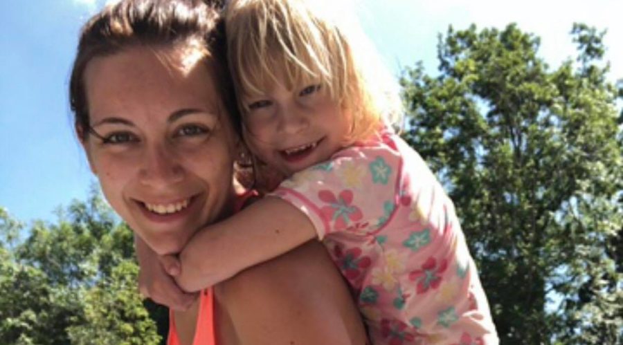 Scarlett having a piggy back from her mum.